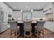 Bright kitchen with white cabinets, granite counters, stainless appliances, and a dark island with barstool seating at 2229 Neills Creek Rd, Lillington, NC 27546