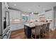 Bright kitchen featuring white cabinets, granite counters, stainless appliances, and a dark island with barstool seating at 2229 Neills Creek Rd, Lillington, NC 27546