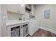 Bright laundry room with modern white appliances and ample counter space for folding at 2229 Neills Creek Rd, Lillington, NC 27546