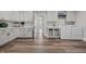 This laundry room features white cabinets, a folding counter, and a washer and dryer at 2229 Neills Creek Rd, Lillington, NC 27546