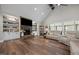 Spacious living room with vaulted ceiling, stone fireplace, built-in shelving, and abundant natural light at 2229 Neills Creek Rd, Lillington, NC 27546