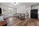 Comfortable living room with a reclining sofa, adjoining the kitchen and featuring access to the porch at 2229 Neills Creek Rd, Lillington, NC 27546