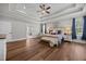 Bright main bedroom with tray ceilings, hardwood floors, large windows, and decorative accents at 2229 Neills Creek Rd, Lillington, NC 27546