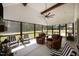 Inviting screened porch featuring comfortable seating and a ceiling fan for outdoor enjoyment at 2229 Neills Creek Rd, Lillington, NC 27546