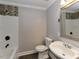 Bathroom with tiled shower and tub, sleek fixtures, vanity with sink and toilet at , Holly Springs, NC 27540