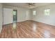 A bright bedroom with wood-look flooring, a ceiling fan, and an ensuite bathroom at , Holly Springs, NC 27540