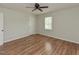 Neutral bedroom with wood-look flooring, a ceiling fan, and natural light at , Holly Springs, NC 27540