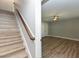 Entry way leading to a bedroom with a ceiling fan, wood floors, and bright, neutral decor for a welcoming feel at , Holly Springs, NC 27540