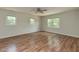 Spacious bedroom featuring three windows, a ceiling fan, and wood-look flooring at , Holly Springs, NC 27540