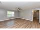 Large bedroom with wood floors, neutral walls, a ceiling fan, and natural light from a window at , Holly Springs, NC 27540