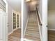 Home entryway with light wood stairs, door with glass and view to living space at , Holly Springs, NC 27540