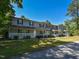 Inviting townhome showcasing covered front porches and lush landscaping, perfect for relaxation at , Holly Springs, NC 27540