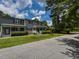 Charming gray two-story townhouse with inviting front porch, complemented by well-maintained landscaping at , Holly Springs, NC 27540