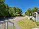 Exterior view of a townhome featuring a well-maintained lawn and mature trees at , Holly Springs, NC 27540