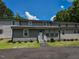 A gray townhouse with a well-maintained lawn, inviting front entrance, and ample parking space at , Holly Springs, NC 27540