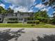 Inviting townhouse featuring a covered front porch with white railings and lush landscaping at , Holly Springs, NC 27540