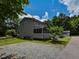 A charming gray townhouse with a cozy screened in porch, nestled among lush greenery and a tranquil gravel yard at , Holly Springs, NC 27540