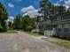 Gray townhouse with inviting front entrance, featuring well-maintained landscaping and ample parking in driveway at , Holly Springs, NC 27540