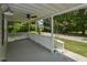 Front porch with white railings offers serene outdoor living space with a calming view of the surrounding nature at , Holly Springs, NC 27540