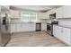 Modern kitchen featuring white cabinets, stainless steel appliances, and hardwood-style floors at , Holly Springs, NC 27540