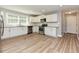 Modern kitchen featuring white cabinets, stainless steel appliances, and hardwood-style floors at , Holly Springs, NC 27540