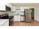 Modern kitchen featuring white cabinets, stainless steel appliances, and subway tile backsplash at , Holly Springs, NC 27540
