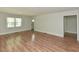 Large living room featuring wood-look floors, neutral walls and natural lighting at , Holly Springs, NC 27540
