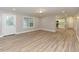Spacious, open-concept living room with hardwood floors and natural light, leading into a modern kitchen at , Holly Springs, NC 27540