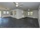 Spacious living room with three ceiling fans, black floor, and lots of windows for plenty of natural light at , Holly Springs, NC 27540