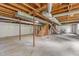 Spacious unfinished basement featuring exposed beams and concrete flooring, ready for customization at 2291 Gentry Ridge Rd, Roxboro, NC 27574