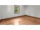 Simple bedroom with hardwood flooring and a bright window at 2291 Gentry Ridge Rd, Roxboro, NC 27574