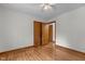 Bedroom with hardwood floors, white walls and ceiling, and doors leading to the bathroom and closet at 2291 Gentry Ridge Rd, Roxboro, NC 27574