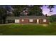 Brick home with a covered parking area, set against a backdrop of a vibrant sunset at 2291 Gentry Ridge Rd, Roxboro, NC 27574
