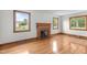 Living room boasts natural light, hardwood floors, a decorative fireplace, and charming wood trim at 2291 Gentry Ridge Rd, Roxboro, NC 27574