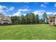 Expansive backyard with lush green lawn, mature trees, and plenty of space for outdoor activities at 2300 Ginger Gold Court, Apex, NC 27539
