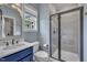 Stylish bathroom with a modern vanity, sleek shower, and natural light streaming through the window at 2300 Ginger Gold Court, Apex, NC 27539