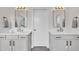 Bathroom with gray cabinets, dual sinks, framed mirrors, and wood look floors at 2300 Ginger Gold Court, Apex, NC 27539
