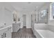 Bright bathroom with double vanity, soaking tub, and glass-enclosed shower at 2300 Ginger Gold Court, Apex, NC 27539