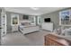 Bright bedroom with a large bed, two windows offering natural light, and a cozy seating area at 2300 Ginger Gold Court, Apex, NC 27539