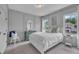 Serene bedroom with soft gray walls, elegant molding, and a comfortable bed near bright windows at 2300 Ginger Gold Court, Apex, NC 27539