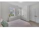Cozy bedroom with neutral walls, carpeted floor, and natural light from two windows at 2300 Ginger Gold Court, Apex, NC 27539