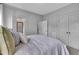 Tranquil bedroom featuring a plush bed, stylish gray walls, and access to ensuite bathroom and closets at 2300 Ginger Gold Court, Apex, NC 27539