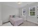Cozy bedroom with neutral walls, carpeted floor, and natural light from two windows at 2300 Ginger Gold Court, Apex, NC 27539