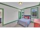 Bedroom featuring green trim and abundant natural light at 2300 Ginger Gold Court, Apex, NC 27539