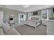 Spacious bedroom with neutral tones, a comfortable bed, and a glimpse into the ensuite bathroom at 2300 Ginger Gold Court, Apex, NC 27539