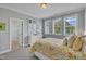 Bright bedroom featuring neutral walls, three windows, and a floral comforter at 2300 Ginger Gold Court, Apex, NC 27539
