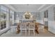 Bright dining room featuring a wooden table, stylish chairs, elegant lighting, and serene decor at 2300 Ginger Gold Court, Apex, NC 27539