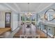 Bright dining room boasting natural light, a wooden table, and an elegant blue accent wall at 2300 Ginger Gold Court, Apex, NC 27539