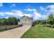 Beautiful home exterior featuring a three-car garage, long driveway, and well-maintained landscaping at 2300 Ginger Gold Court, Apex, NC 27539