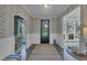 Inviting foyer with patterned wallpaper, wainscoting, hardwood floors, and views to other rooms at 2300 Ginger Gold Court, Apex, NC 27539